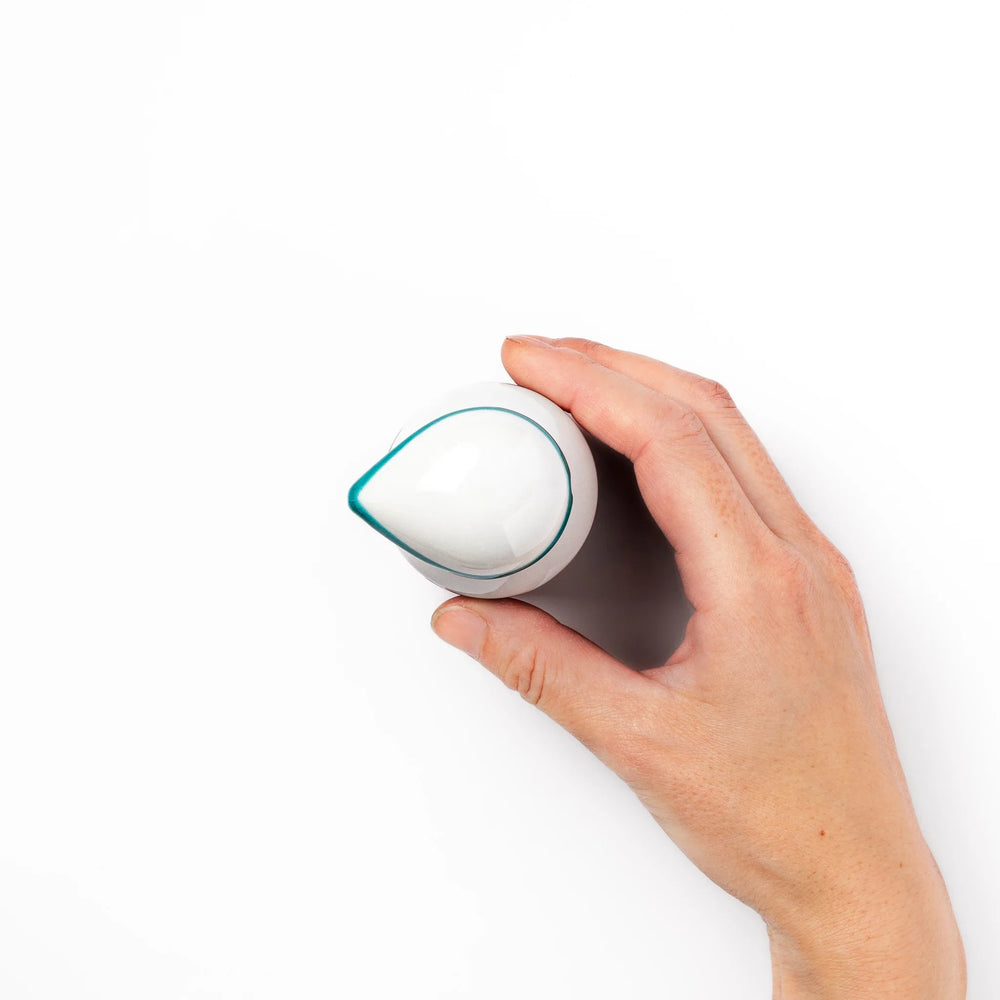 Japanese ceramic soy sauce dispenser with colorful cobblestone mosaic pattern in red green blue and yellow.