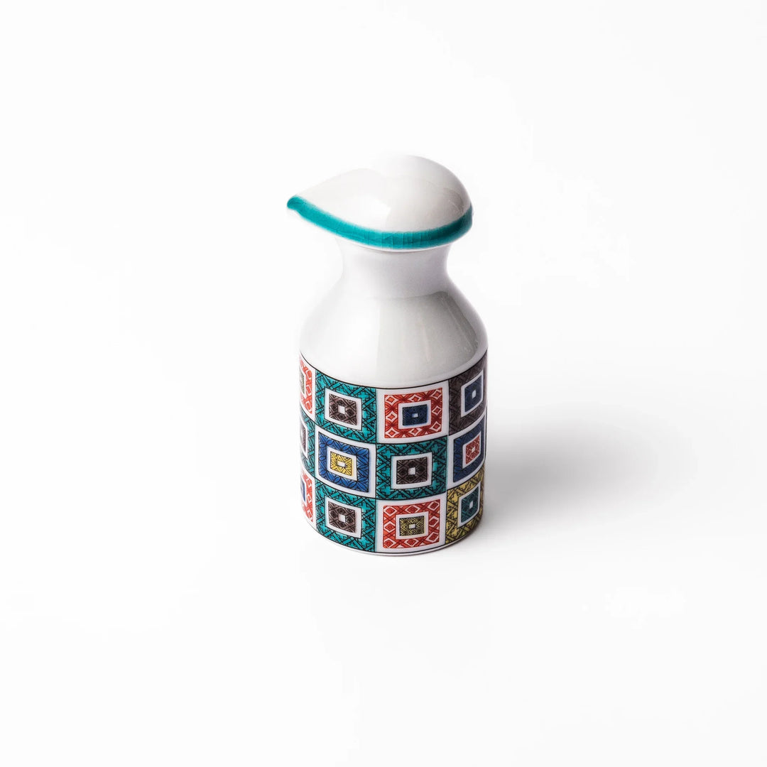 Japanese ceramic soy sauce dispenser with colorful cobblestone mosaic pattern in red green blue and yellow.