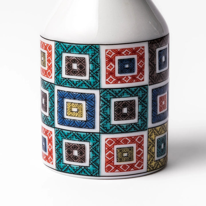 Japanese ceramic soy sauce dispenser with colorful cobblestone mosaic pattern in red green blue and yellow.