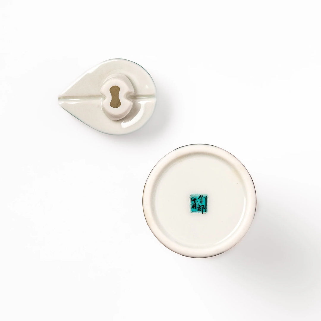 Japanese ceramic soy sauce dispenser with colorful cobblestone mosaic pattern in red green blue and yellow.