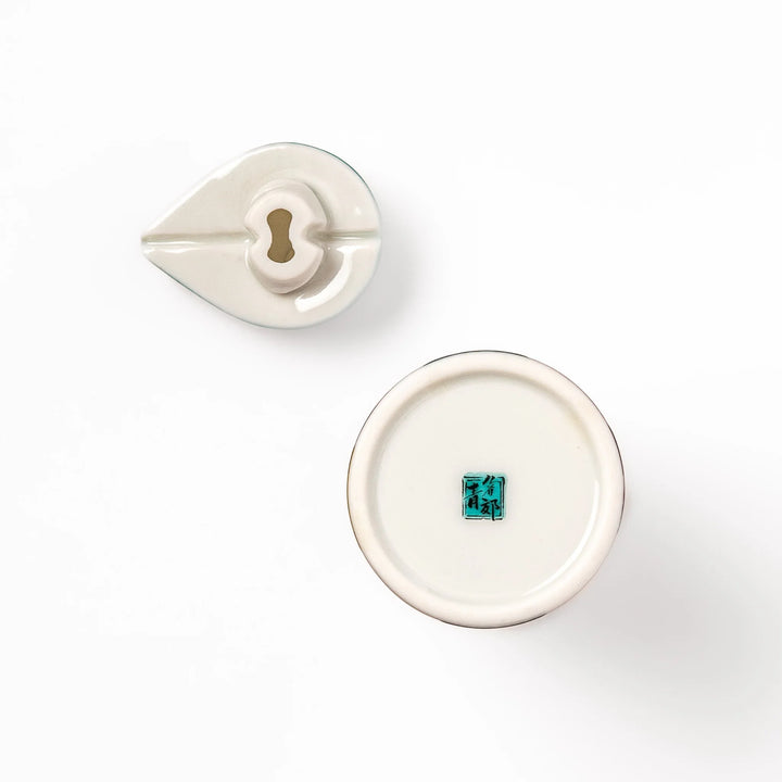 Japanese ceramic soy sauce dispenser with colorful cobblestone mosaic pattern in red green blue and yellow.