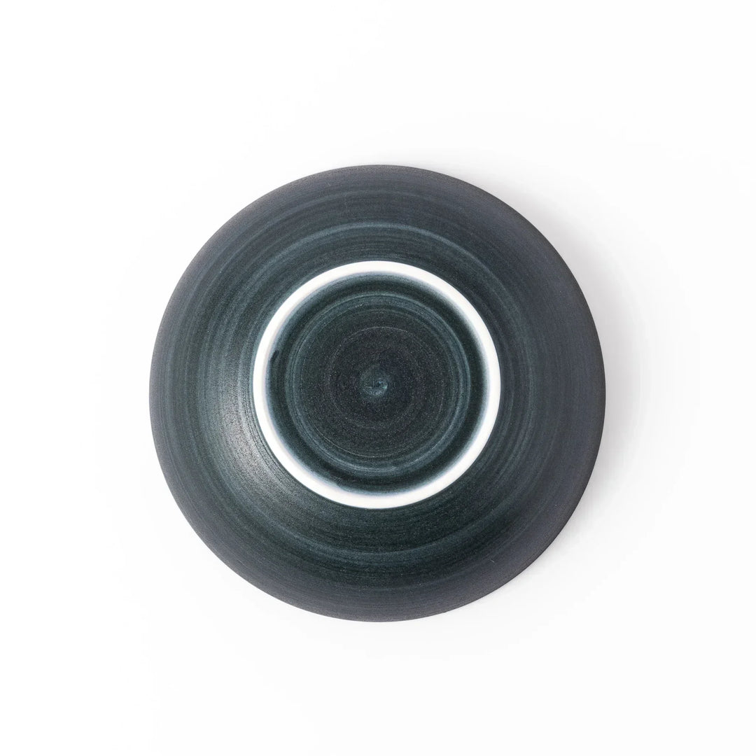 Deep navy ceramic bowl with subtle concentric lines and matte finish, softly flared rim against a white background