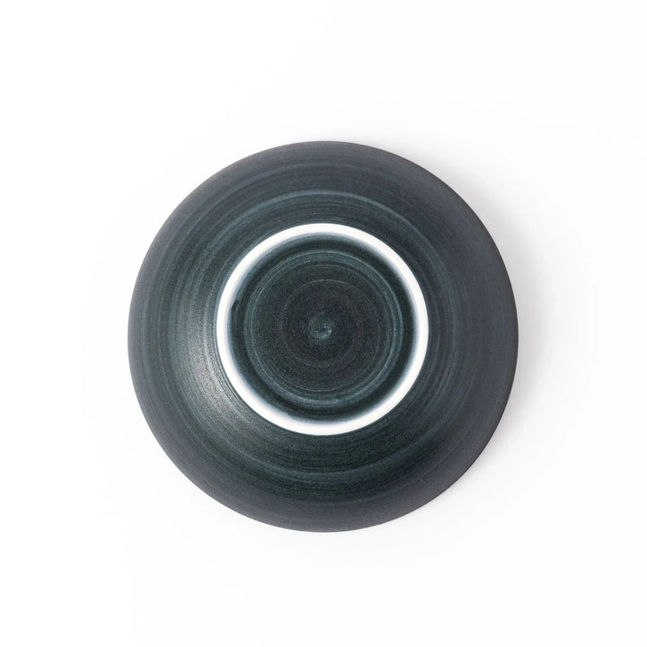 Deep navy ceramic bowl with subtle concentric lines and matte finish, softly flared rim against a white background