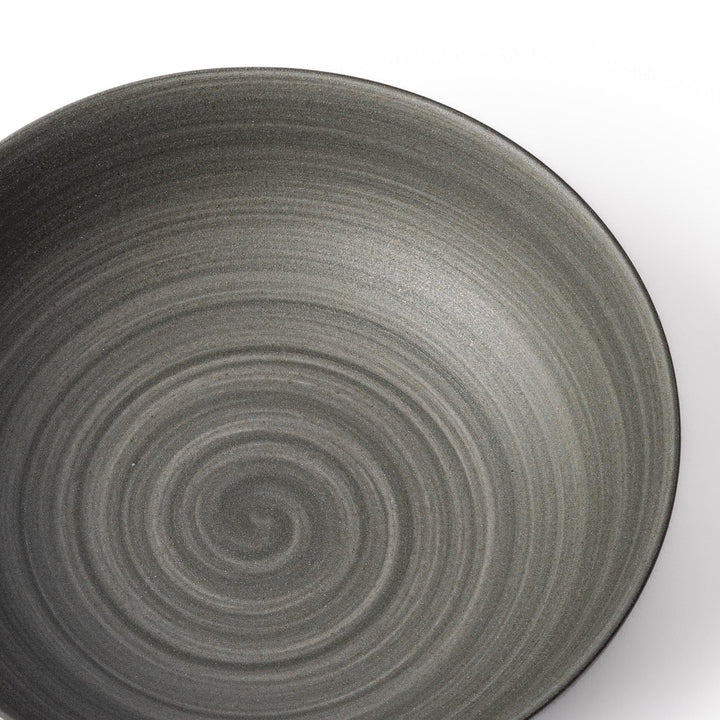 Smooth matte grey ceramic bowl with fine concentric ridges and gently flared rim against a clean white background