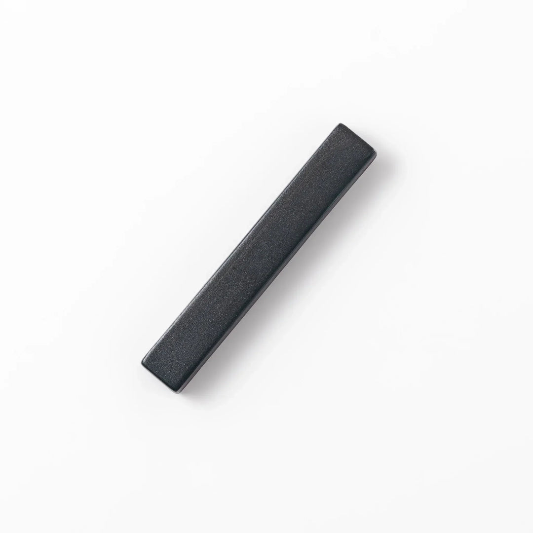 Rectangular ceramic chopstick rest in deep navy with a smooth matte surface and softly rounded edges