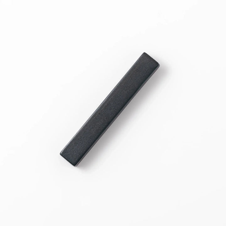 Rectangular ceramic chopstick rest in deep navy with a smooth matte surface and softly rounded edges