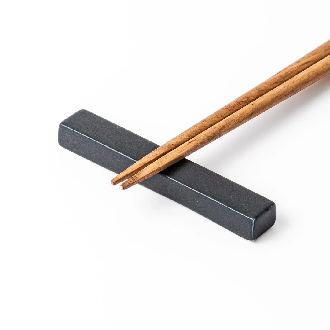Rectangular ceramic chopstick rest in deep navy with a smooth matte surface and softly rounded edges