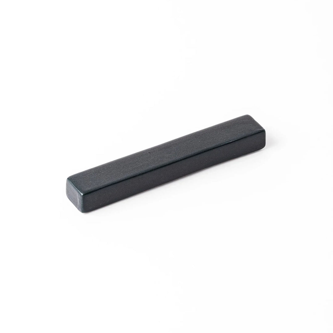 Rectangular ceramic chopstick rest in deep navy with a smooth matte surface and softly rounded edges