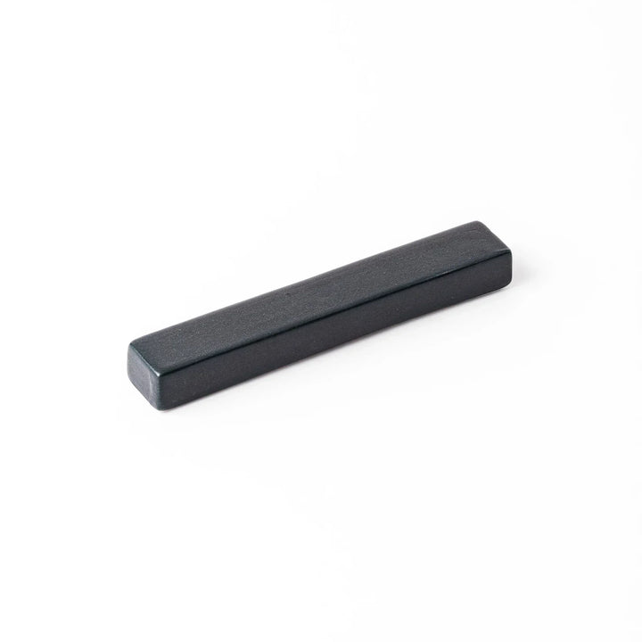 Rectangular ceramic chopstick rest in deep navy with a smooth matte surface and softly rounded edges
