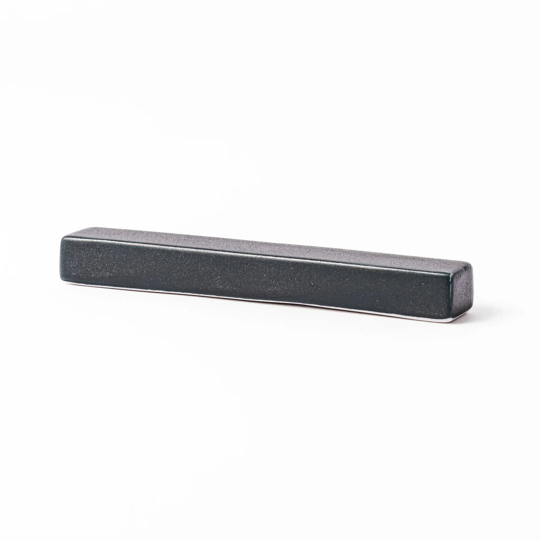 Rectangular ceramic chopstick rest in deep navy with a smooth matte surface and softly rounded edges