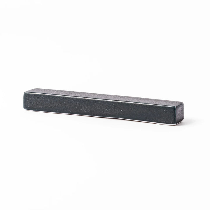 Rectangular ceramic chopstick rest in deep navy with a smooth matte surface and softly rounded edges