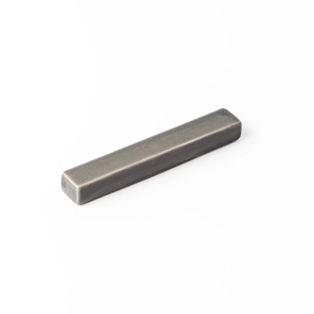 Rectangular ceramic chopstick rest in a soft gray Japandi tone with clean edges and a smooth matte finish