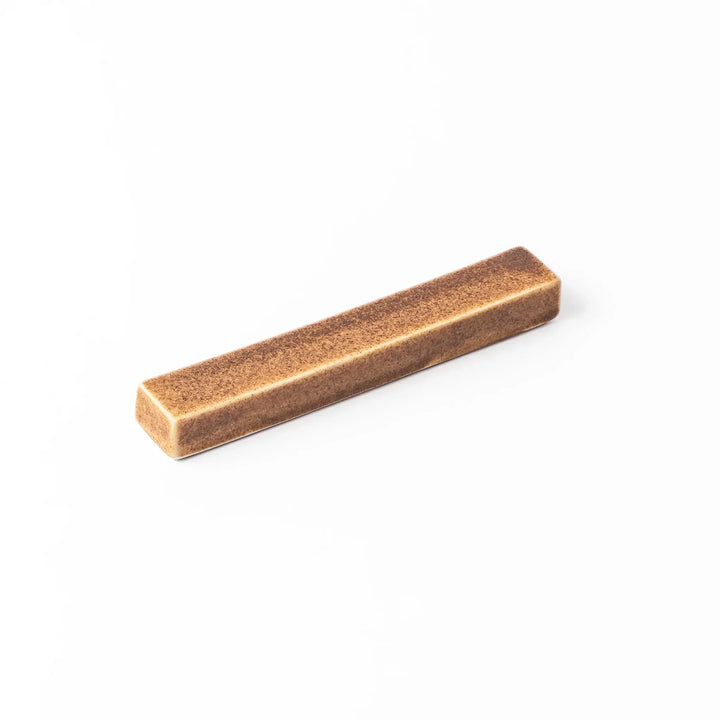 Rectangular ceramic chopstick rest in a warm beige Japandi tone with a minimalist form and smooth glazed finish