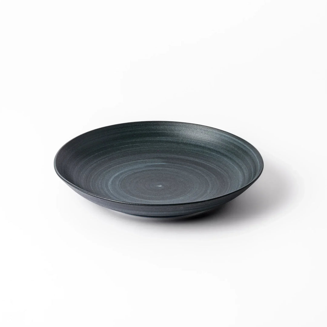 Matte navy blue salad plate with swirling concentric texture and softly curved rim for a calm, modern feel.