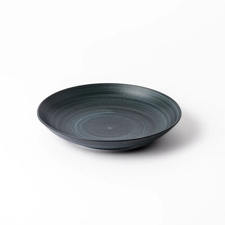 Matte navy blue salad plate with swirling concentric texture and softly curved rim for a calm, modern feel.