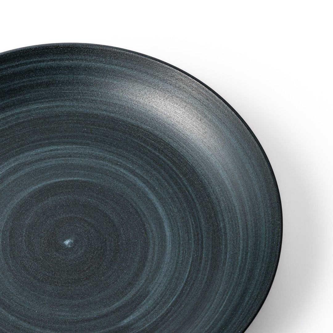 Matte navy blue salad plate with swirling concentric texture and softly curved rim for a calm, modern feel.