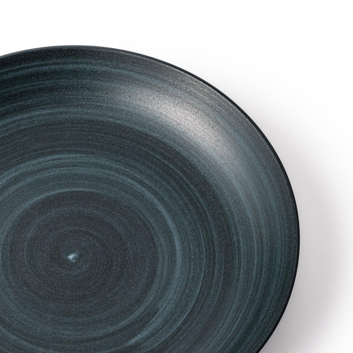 Matte navy blue salad plate with swirling concentric texture and softly curved rim for a calm, modern feel.