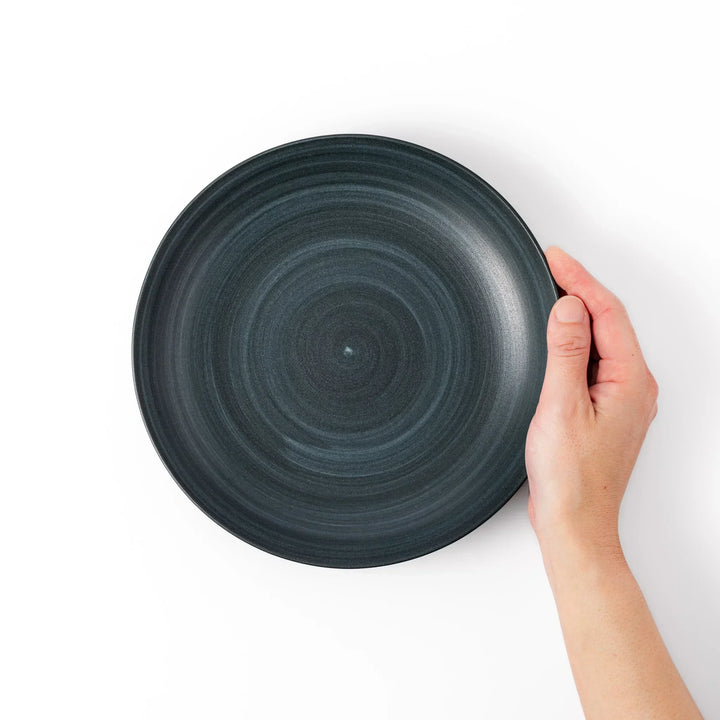 Matte navy blue salad plate with swirling concentric texture and softly curved rim for a calm, modern feel.
