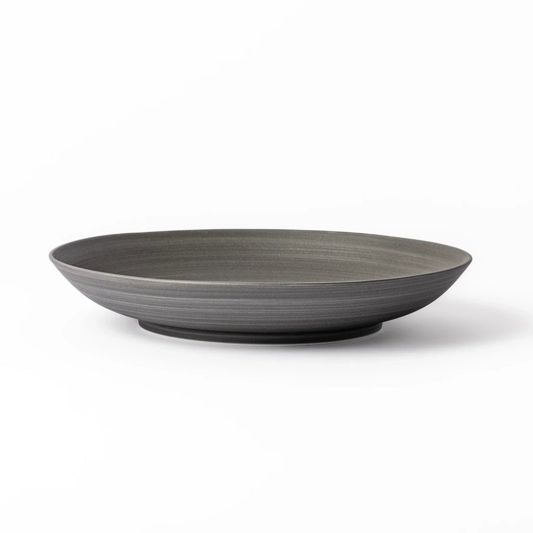 Matte gray salad plate with subtle concentric texture and gently curved sides for a modern Japandi look.