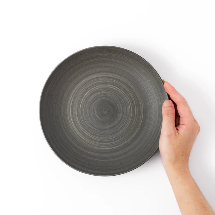 Matte gray salad plate with subtle concentric texture and gently curved sides for a modern Japandi look.