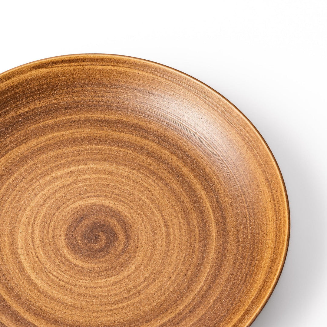 Warm-toned matte brown salad plate featuring soft concentric rings and a gentle curve, perfect for Japandi-style dining.
