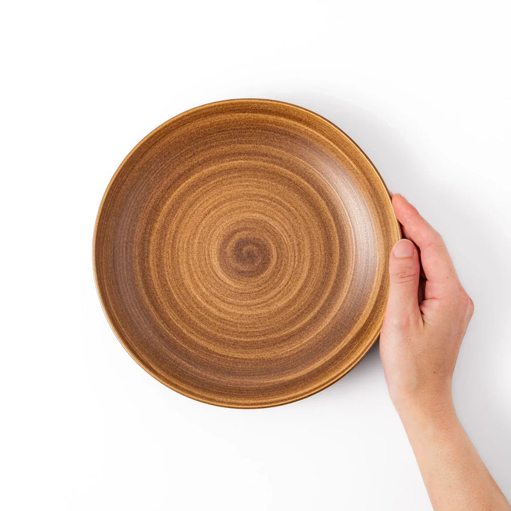 Warm-toned matte brown salad plate featuring soft concentric rings and a gentle curve, perfect for Japandi-style dining.