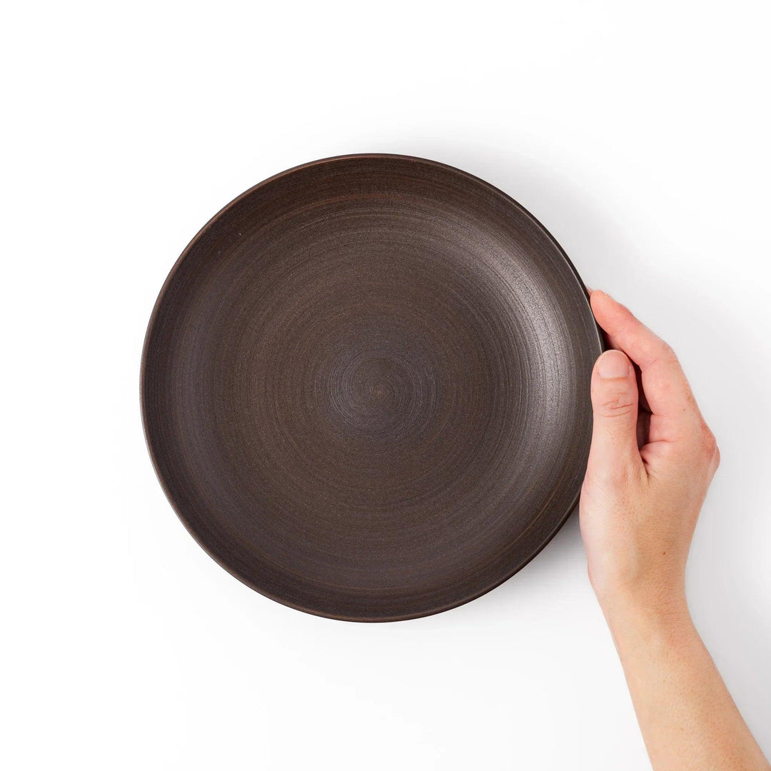 Matte brown ceramic salad plate with subtle swirl lines and a gently raised rim, perfect for modern Japandi table settings.