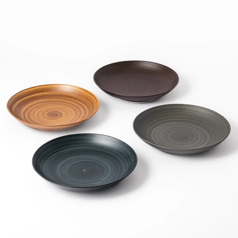 Set of earthy matte salad plates with swirl patterns, perfect for Japandi-inspired dining.