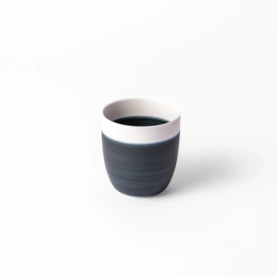 Two-tone tea cup with ivory rim and deep blue base, ideal for serene tea moments in Japandi settings.