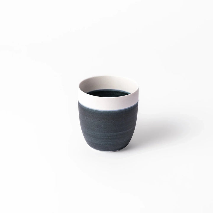Two-tone tea cup with ivory rim and deep blue base, ideal for serene tea moments in Japandi settings.
