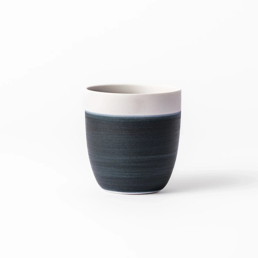 Two-tone tea cup with ivory rim and deep blue base, ideal for serene tea moments in Japandi settings.