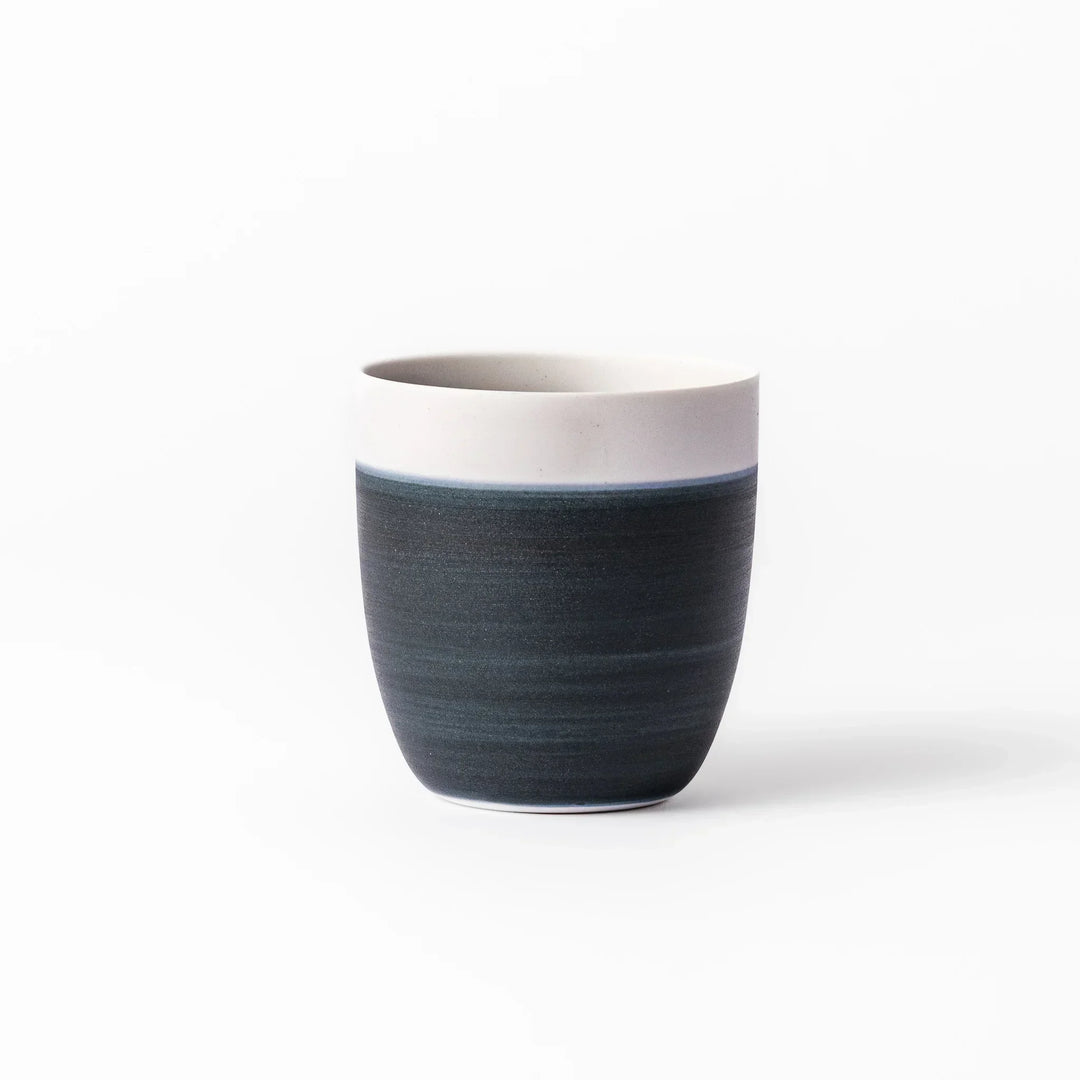 Two-tone tea cup with ivory rim and deep blue base, ideal for serene tea moments in Japandi settings.