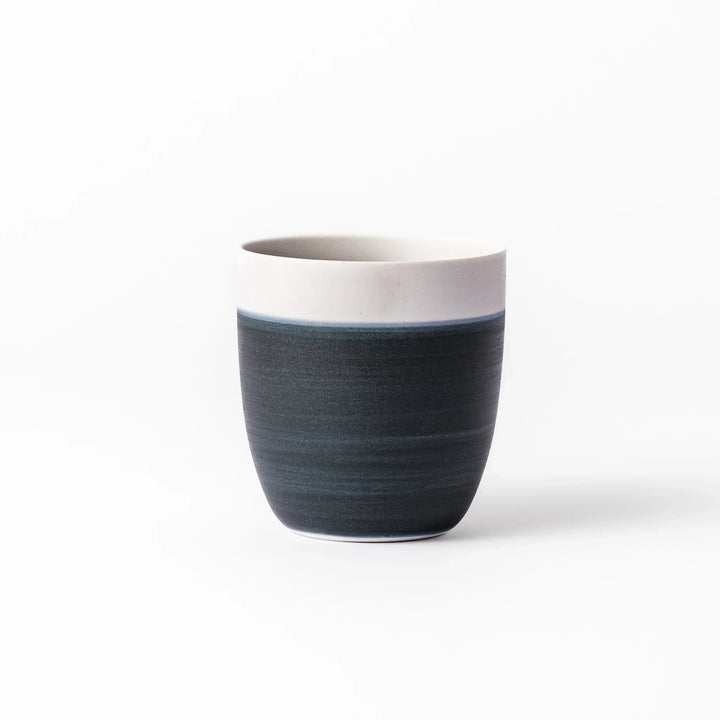 Two-tone tea cup with ivory rim and deep blue base, ideal for serene tea moments in Japandi settings.