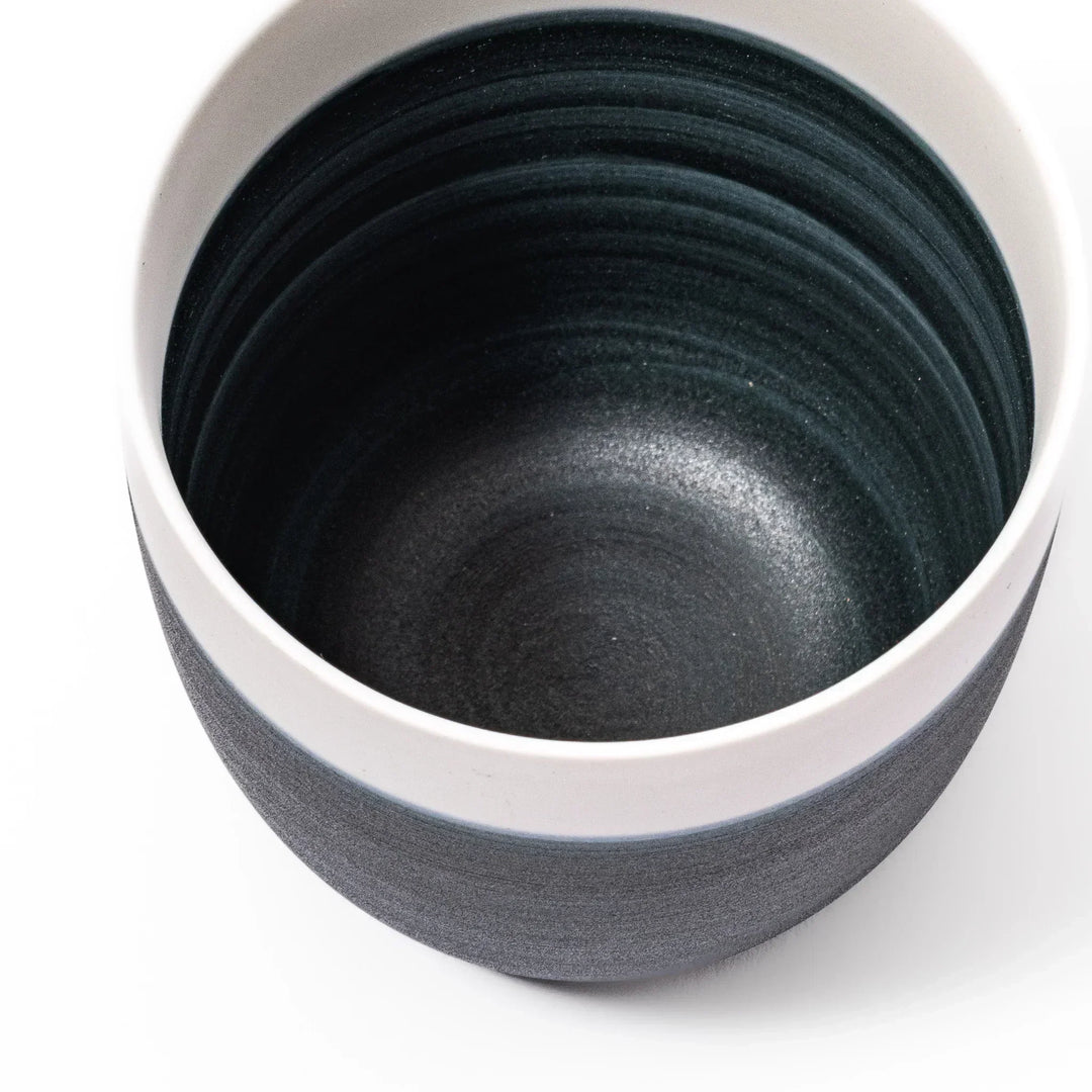 Two-tone tea cup with ivory rim and deep blue base, ideal for serene tea moments in Japandi settings.