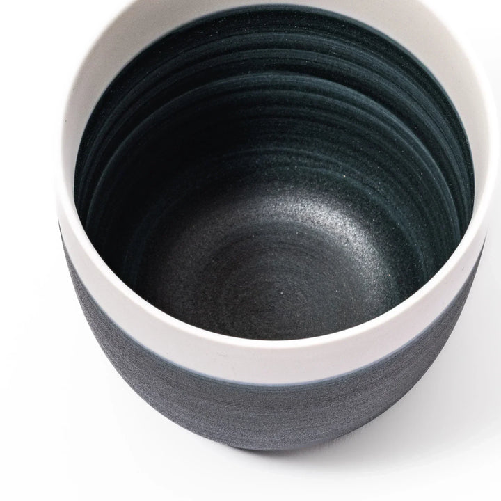 Two-tone tea cup with ivory rim and deep blue base, ideal for serene tea moments in Japandi settings.