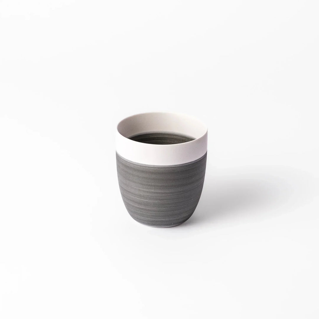 Two-tone tea cup with ivory rim and gray base, ideal for calm tea moments and Japandi tables.