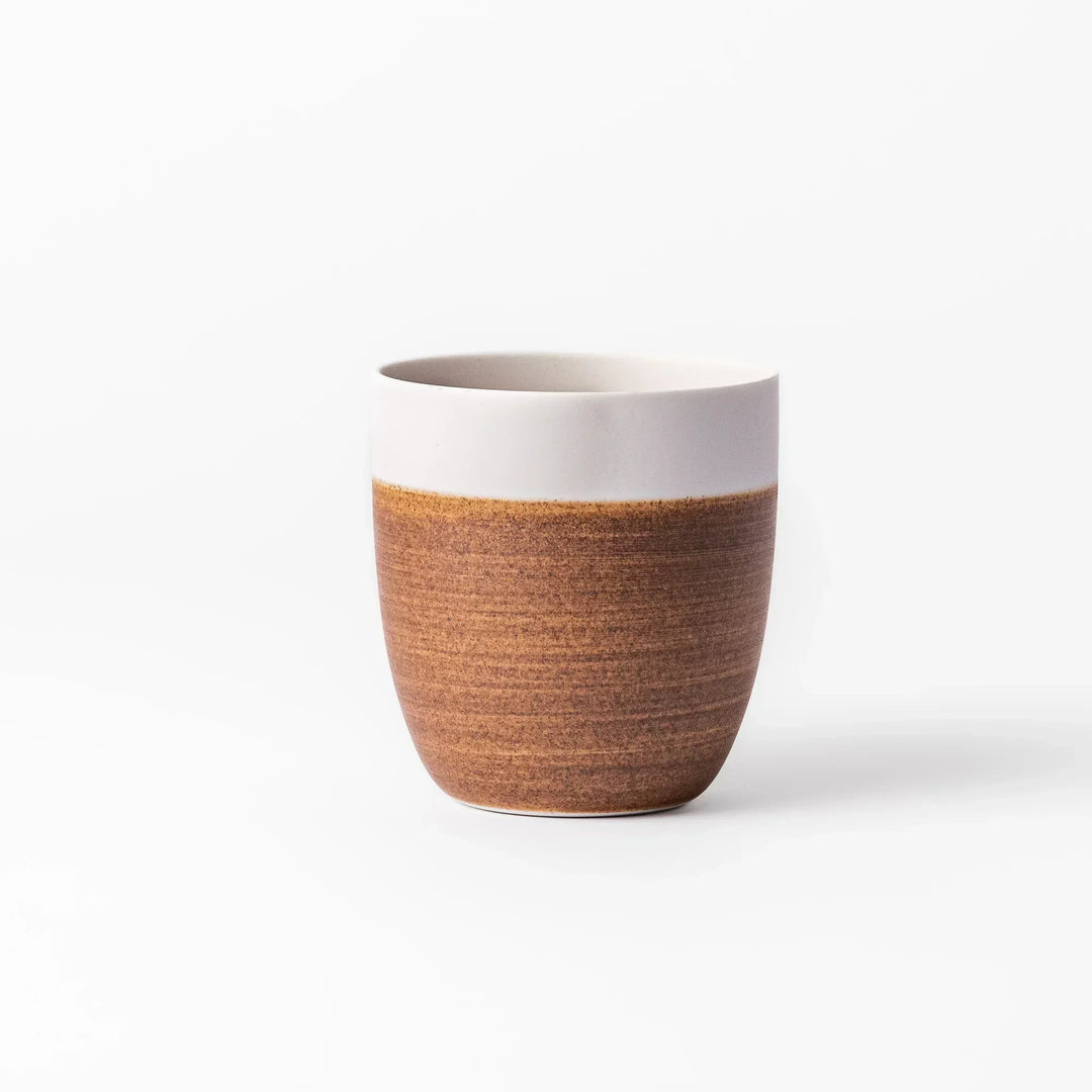 Two-tone tea cup with ivory rim and caramel base, perfect for cozy sips and Japandi-style tables.