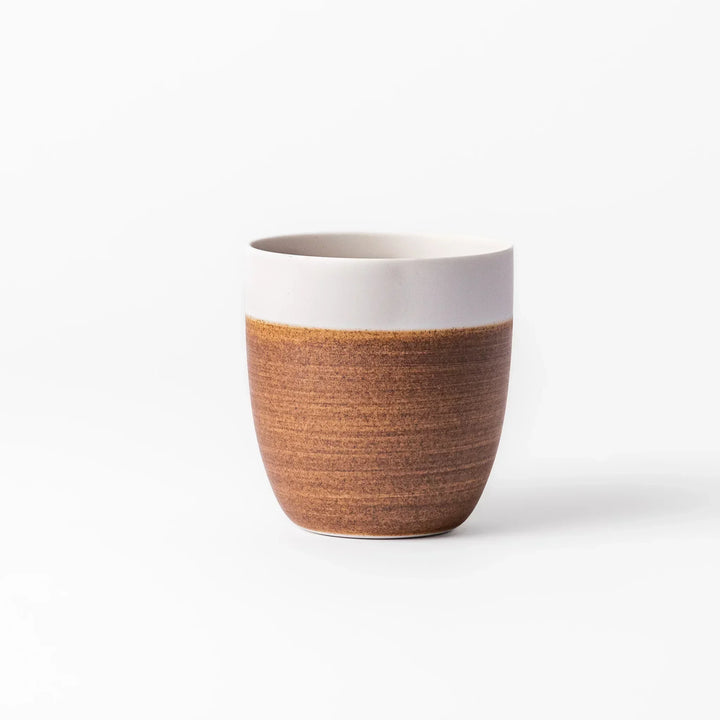 Two-tone tea cup with ivory rim and caramel base, perfect for cozy sips and Japandi-style tables.