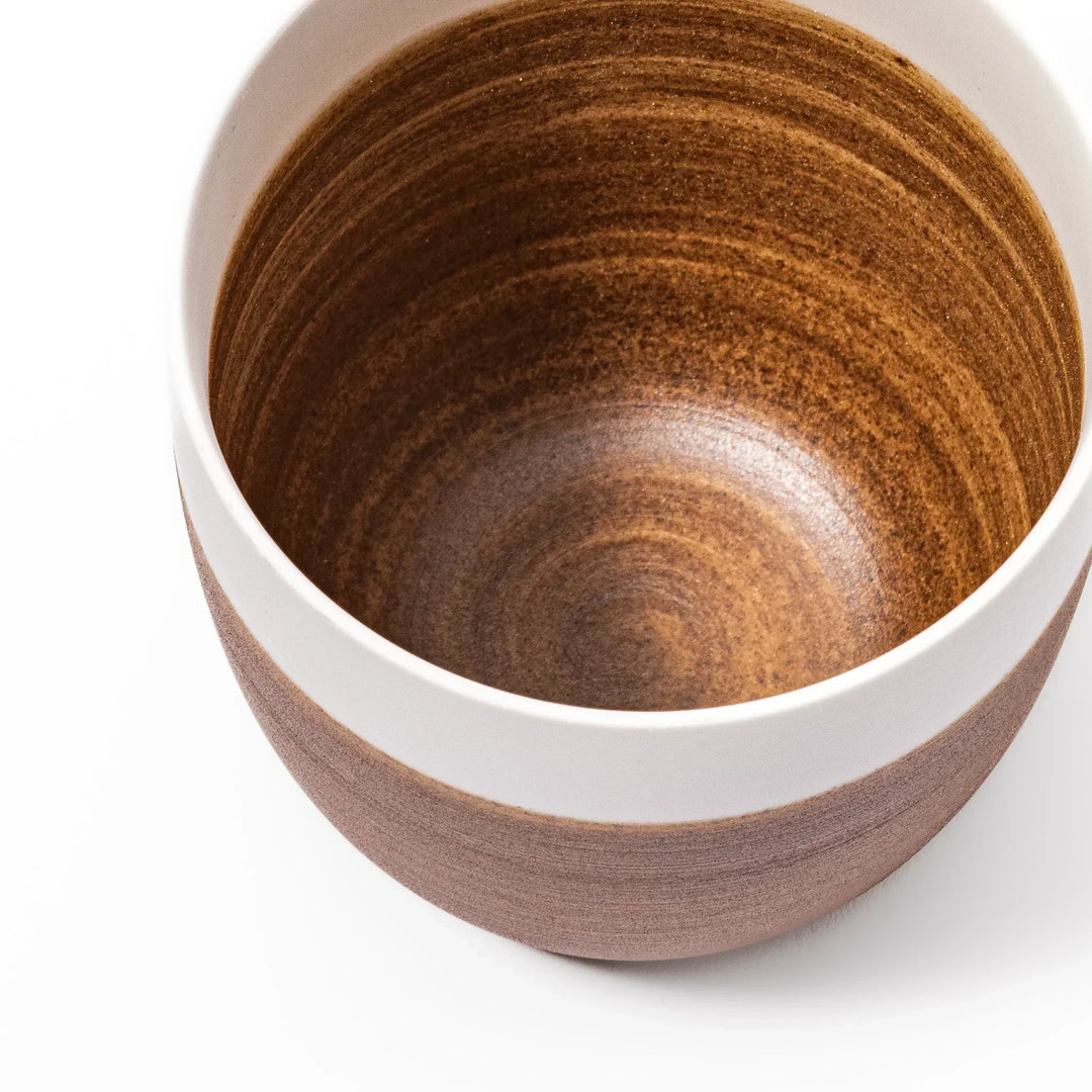 Two-tone ceramic tea cup with a matte ivory rim and warm caramel-toned base. Perfect for cozy sips and Japandi-style tables.