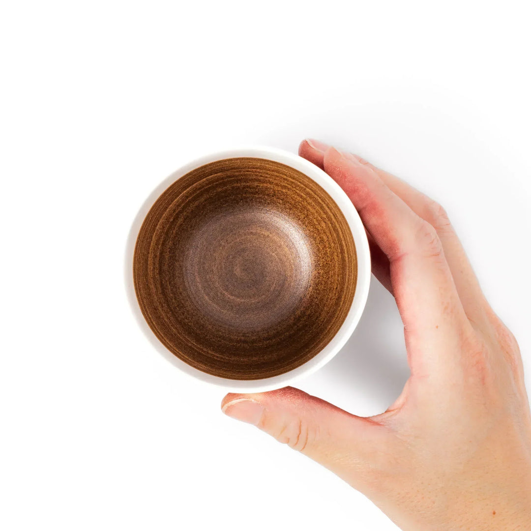 Two-tone ceramic tea cup with a matte ivory rim and warm caramel-toned base. Perfect for cozy sips and Japandi-style tables.