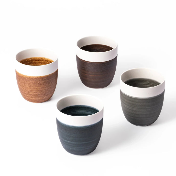 Set of four Japandi tea cups with matte ivory rims and earthy tones, perfect for cozy minimalist interiors.