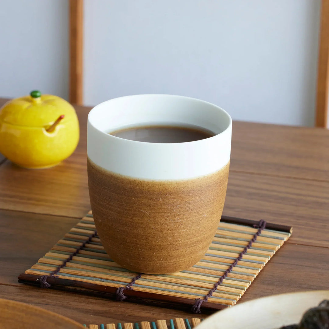 Japandi tea cups in brown and white, blending rustic warmth with modern minimal design.