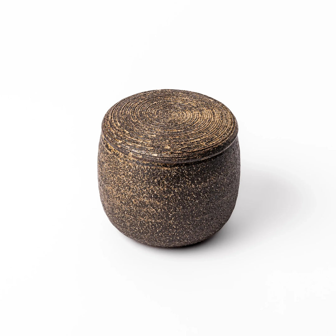 Dark brown ceramic rice storage bowl with lid and rustic texture for storing and serving cooked rice.