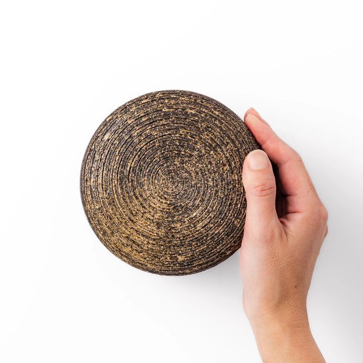 Dark brown ceramic rice storage bowl with lid and rustic texture for storing and serving cooked rice.