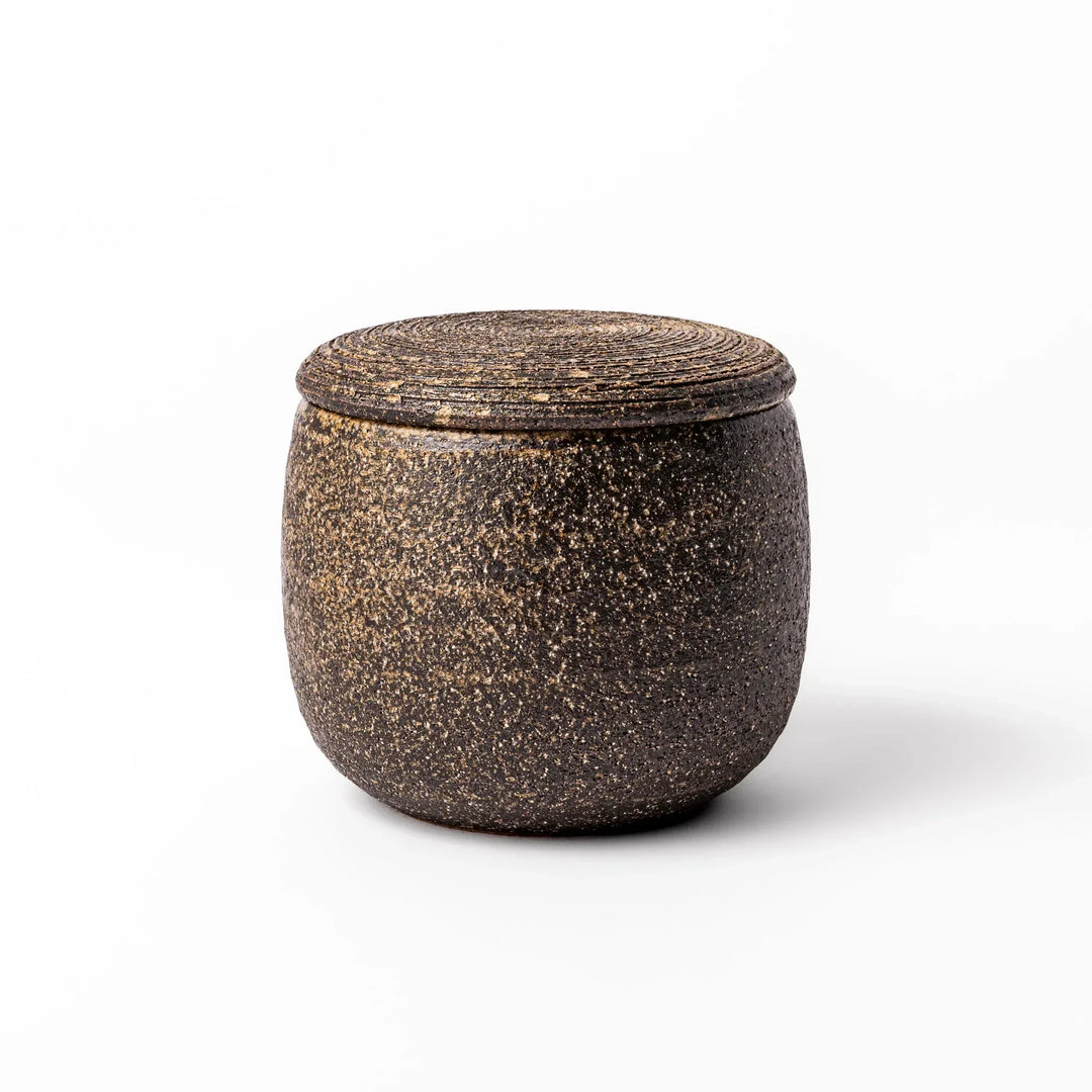 Dark brown ceramic rice storage bowl with lid and rustic texture for storing and serving cooked rice.
