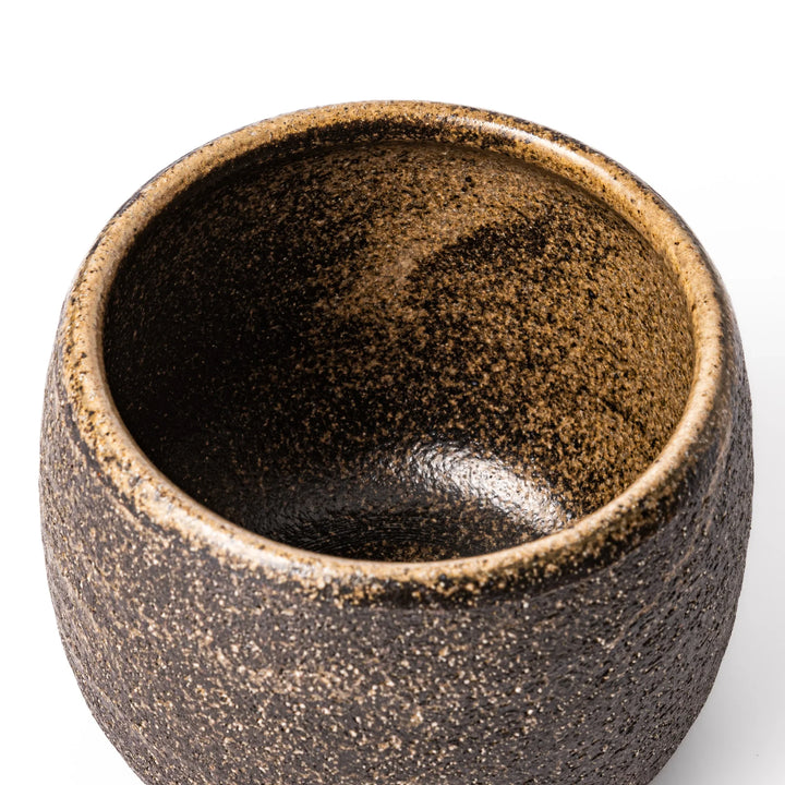 Dark brown ceramic rice storage bowl with lid and rustic texture for storing and serving cooked rice.