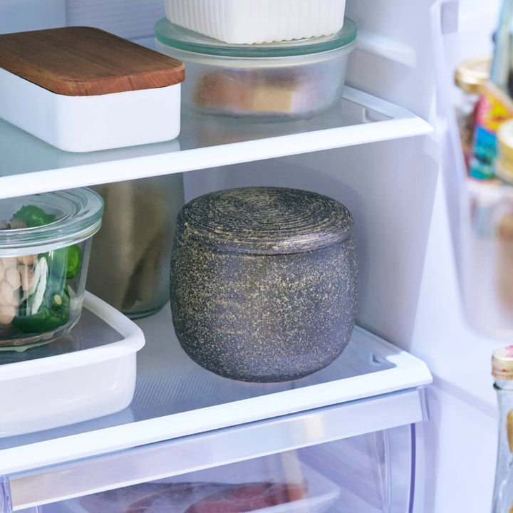 Dark brown ceramic rice storage bowl with lid and rustic texture for storing and serving cooked rice.