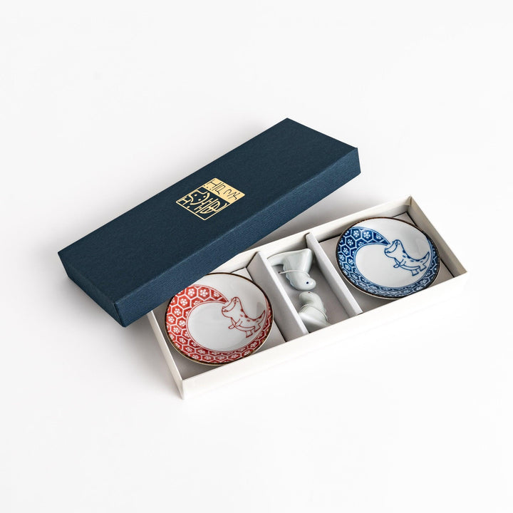 Two small dinosaur design sauce plates with matching chopstick rests adding playful charm to dining.