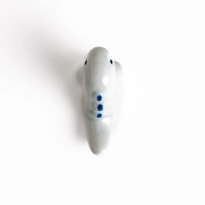 White ceramic dinosaur chopstick rest bringing playful charm to table settings while keeping chopsticks clean.