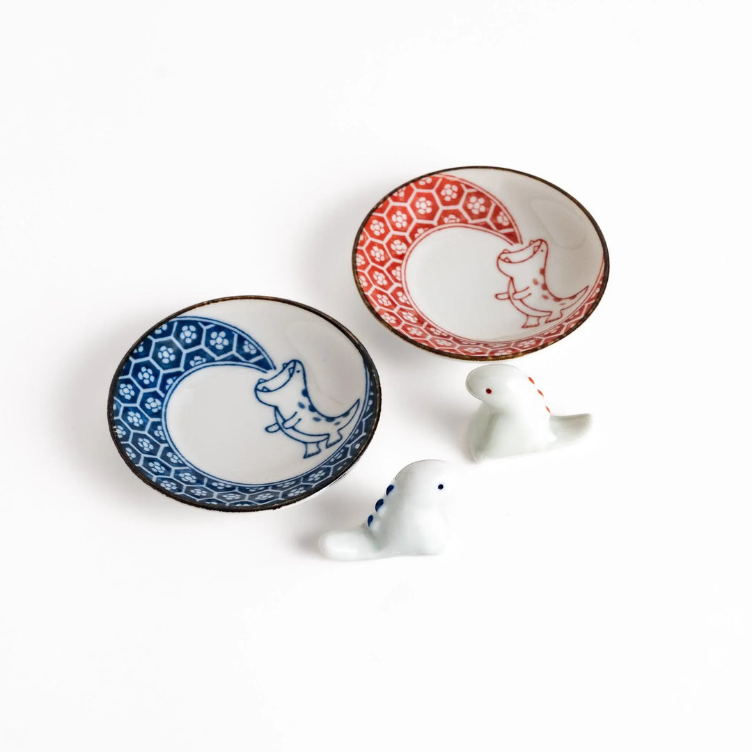 Two small dinosaur design sauce plates with matching chopstick rests adding playful charm to dining.